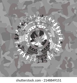 marijuana leaf icon inside grey camouflaged emblem. 