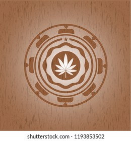 marijuana leaf icon inside realistic wooden emblem
