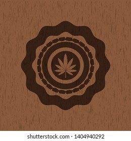 marijuana leaf icon inside realistic wood emblem