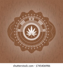 ícono de la hoja de marihuana dentro del emblema de madera retro. 