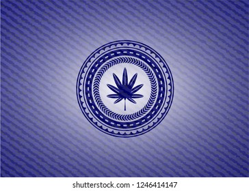 marijuana leaf, weed icon inside emblem with jean background