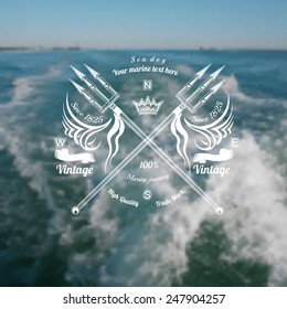 marine background with trident cross label on blue sea with foam from ship blur photo