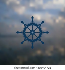 Marine steering wheel, classic style, located in the blurred background. On the background of sea and sky