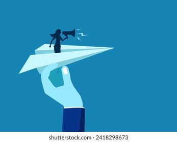 Marketing leader. Big hands help a businesswoman hold a megaphone on a paper airplane