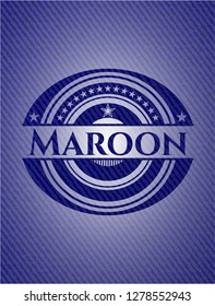 Maroon badge with denim background