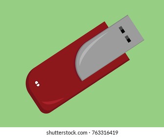 Maroon and silver pen drive in a green background
