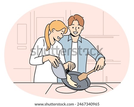 Married couple prepares breakfast enjoying sunday morning and experiencing happiness from communicating with loved one. Happy couple of man and woman cooking pancakes or omelet together