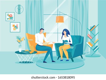 Married Couple Spends Time Reading Books at Home. Man and Woman are Sitting Side by Side in Soft Chairs and Holding Hands, Looking at their Favorite Books. On Coffee Table are Cups Tea and Sweets.