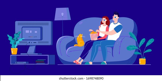 A married couple is watching a 3D movie on a large screen, sitting on a sofa at home in a dark room. Self-isolation at home.