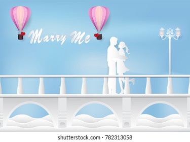 Marry me. Man making proposal for girlfriend on the bridge paper art style, paper craft style illustration background.