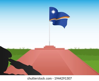 The Marshall Islands flag flew above the pole in the shadow of a soldier saluting the flag