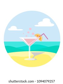 martini on sand with an orange slice on the beach