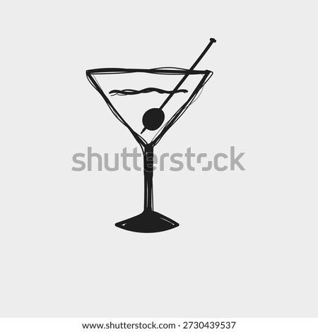 A martini is shown in a clear glass with a thin stem. There is an olive on a stick placed in the drink. The background is plain and white.