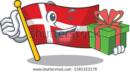 mascot cartoon of happy flag denmark with gift box