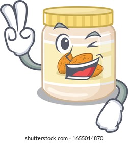 mascot of funny almond butter cartoon Character with two fingers