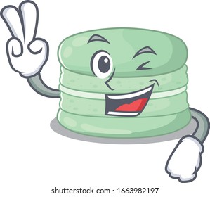 mascot of funny pistachio macaron cartoon Character with two fingers