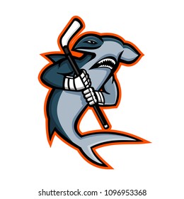 Mascot icon illustration of a hammerhead shark who is a ice hockey player wielding a hockey stick viewed from side on isolated background in retro style.