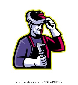 Mascot icon illustration of head of a welder lifting visor and holding welding torch viewed from side on isolated background in retro style.