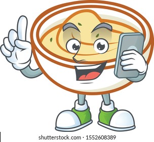 Mashed potatoes cartoon character with mascot with holding phone.