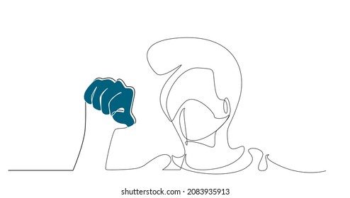 Masked man protesting in the city and clenching his fist. human rights, democracy, freedom protest demonstration.