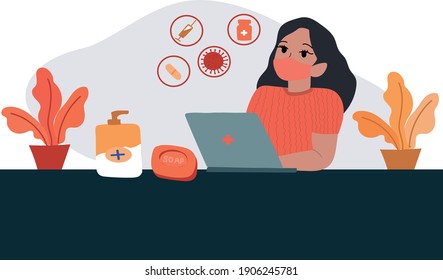 A masked medic sits at a computer.