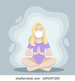 
A masked woman practices yoga at home.
