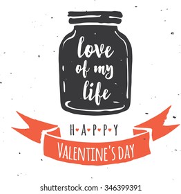 mason jar with heart, love quote on the black chalkboard