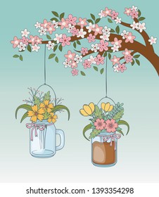 mason jars with flower hanging in tree branch