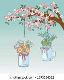 mason jars with flower hanging in tree branch