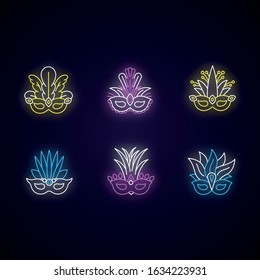 Masquerade masks neon light icons set. Traditional headwear with plumage. Ethnic festival. Brazilian national holiday. Signs with outer glowing effect. Vector isolated RGB color illustrations