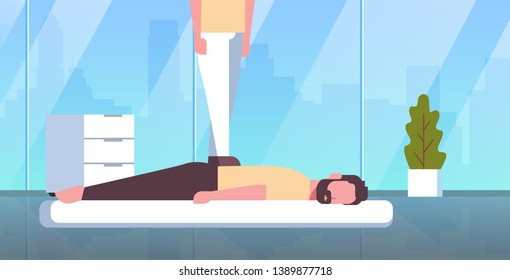 masseuse standing on patient's back doing healing treatment guy relaxing lying on table man having massage spa salon manual therapy concept modern hospital cabinet interior horizontal