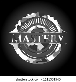Mastery written on a grey camouflage texture Mastery written on a grey camouflage texture