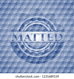 Matted blue emblem with geometric pattern background.
