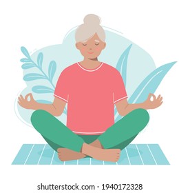 Mature woman meditates on a yoga mat isolated on a white background.