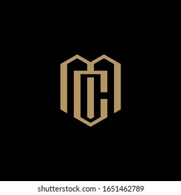 MC monogram logo in shield shape