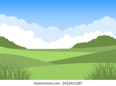 Meadow field landscape. Lush green grass in the foreground. Hills, trees and clouds in the background. Tranquil and bright farmland scenery. Horizontal composition.