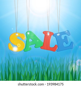 Meadow with green grass on a background of blue sky and sun and message seasonal sales