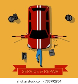 Mechanic Lies Under The Car And Repairs It: Car Repair And Service Concept: Top View