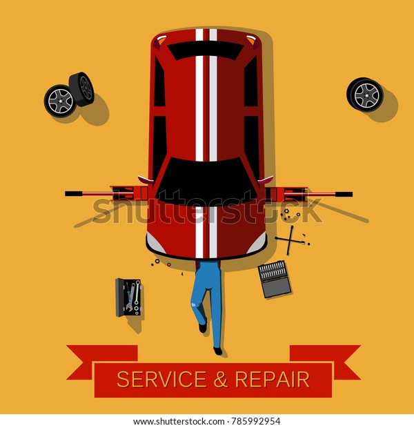 Mechanic lies under the car and repairs it: Car\
repair and service concept: Top\
view