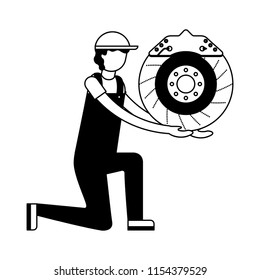 mechanic on the knee with brake disc auto part