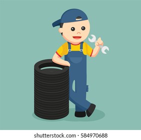 mechanic standing beside sack of tires