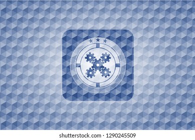 mechanism icon inside blue emblem with geometric pattern.