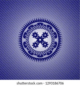 mechanism icon inside denim background