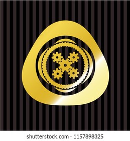 mechanism icon inside gold emblem or badge
