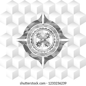 mechanism icon inside grey emblem with geometric cube white background