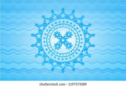 mechanism icon inside light blue water wave badge.