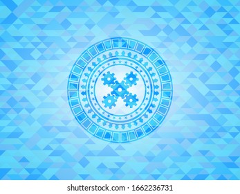mechanism icon inside light blue emblem with triangle mosaic background