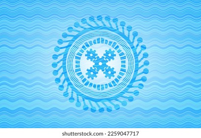 mechanism icon inside light blue water style badge. 