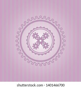 mechanism icon inside pink emblem
