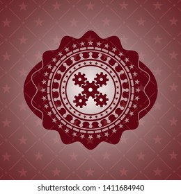 mechanism icon inside red emblem
